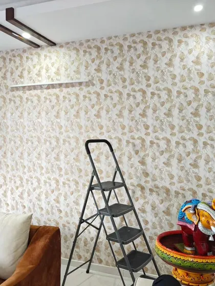 A living room with a subtle leaf pattern wallpaper, creating a calm and neutral backdrop for the space.