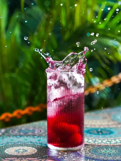 Freezing a moment of action is our specialty. This vibrant splash shot captures the refreshing explosion of a cocktail, highlighting its color and energy. It's a technically challenging but highly effective way to create dynamic beverage photography that grabs attention instantly.