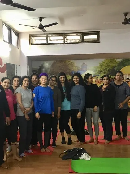 A group photo with our students after an invigorating session. The smiles and sense of community are as important as the asanas themselves.