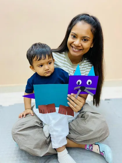 This image captures another proud moment as a mother and son display the craft they made together in our Pitampura class.