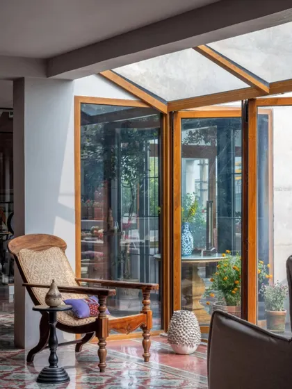 Sunlight streams into this corner of the Dhaka home, illuminating the patterned floor and the handcrafted wooden chair. It’s a perfect example of how I design spaces that change with the light, offering new perspectives throughout the day.