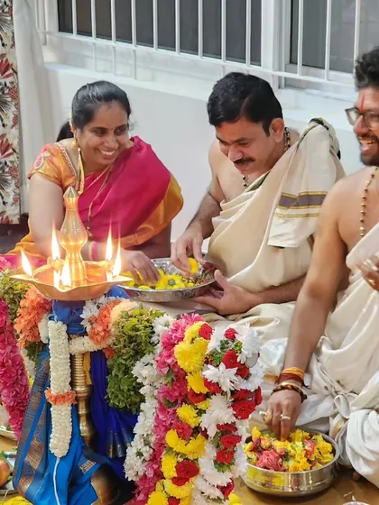 A joyful moment during a Durga Deepa Namaskara pooja, where the family joins in offering flowers. I encourage participation as it enhances the collective devotion and makes the ceremony a truly shared experience.