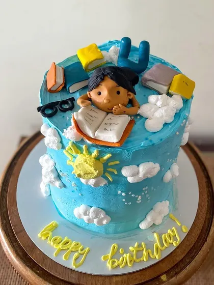 For the book lover in your life! This cake is themed around a perfect summer day: reading a book under the sun. The figurine and books are all handmade from fondant.