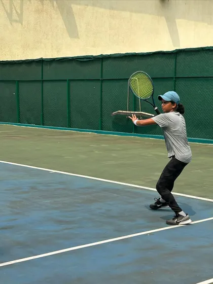 A young player hitting a backhand volley during the MSSA tournament finals, showing great technique under pressure.