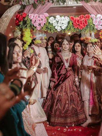 The bride's grand entrance, surrounded by her dancing friends and family. A moment of pure celebration.