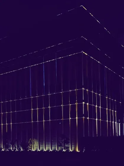 A wide-angle shot of the Zirakpur office project, showing how the illuminated facade establishes a strong presence. The design uses light to define the building's entire volume against the night sky.