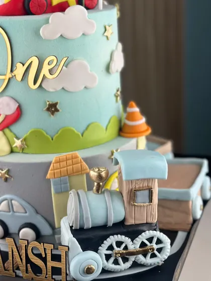 Every kid's dream starts with a cake. This transportation-themed cake for a first birthday is loaded with cars, trains, and planes, turning dreams into a delicious masterpiece.