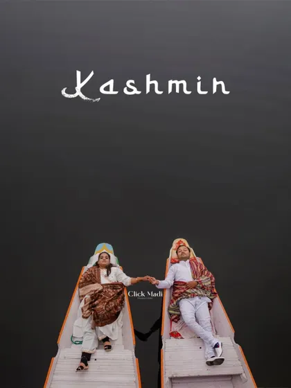 A creative top-down shot of the couple in traditional Kashmiri attire, holding hands in separate boats on Dal Lake. This artistic composition emphasizes their connection and the unique culture of the location.