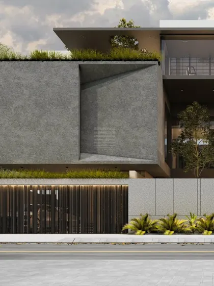 The 'House of Courtyards' features a facade that integrates dark concrete textures with vertical wooden slats. This material contrast provides visual depth and responds to the climate by creating shaded, semi-enclosed spaces.