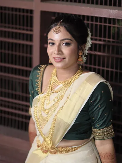 A close-up of the Kerala bride's beautiful makeup. The look is fresh and dewy, with a focus on natural-looking skin.