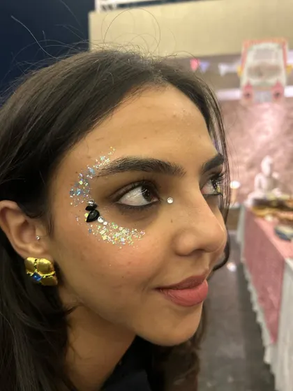 A bold crescent of silver glitter with a few black gems for contrast. This is a great look for a concert or a festival.