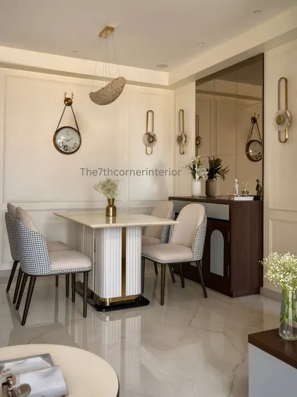 A wide view of a cozy dining corner, designed to be a warm and welcoming space. The design features a mix of chair styles, including a houndstooth pattern, adding visual interest and personality.