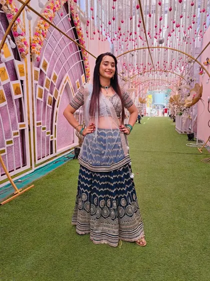 Another shot of the client in the navy blue printed lehenga, looking happy and comfortable.
