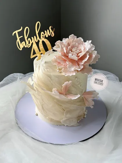 Nothing but the best for your special one. A stunning 40th birthday cake featuring delicate rice paper sails and a large, handcrafted sugar peony.