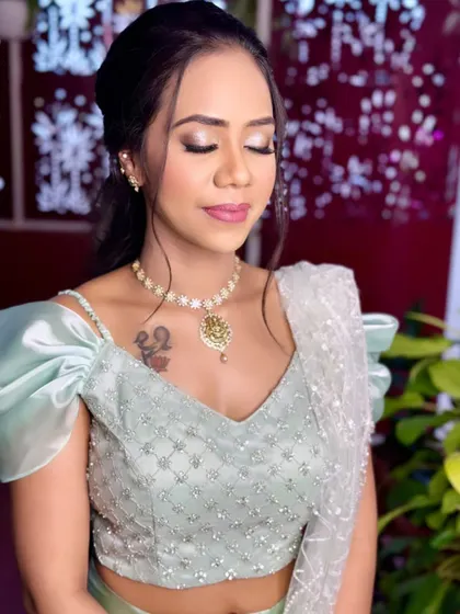 A close-up of Apoorva's eye makeup, showing the soft blend of champagne and rose gold shimmers.
