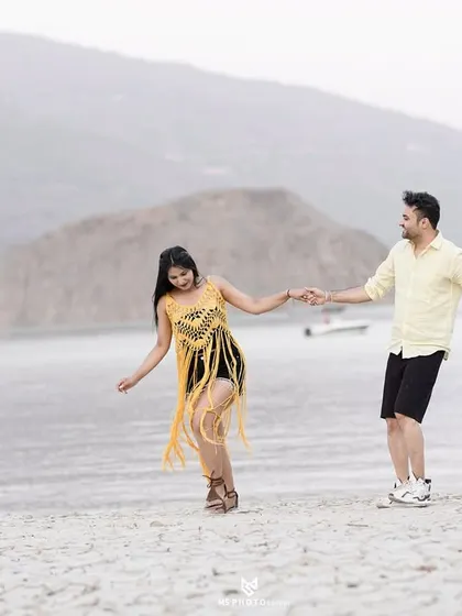 A joyful, movement-filled shot of the couple on the shores of the lake. This captures their energy and happiness in a natural way.
