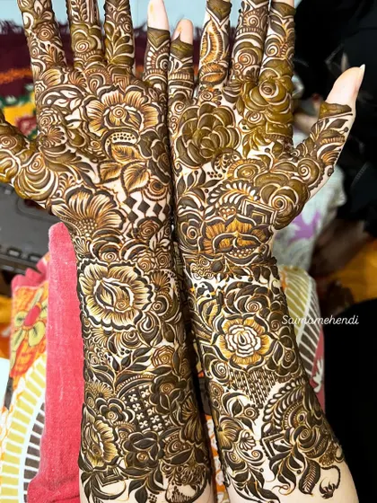 This design is a beautiful example of a floral-heavy pattern, with different types of flowers and leaves creating a lush, garden-like effect on the arms.