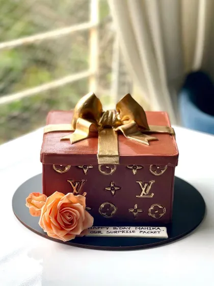 For the fashion lover, a cake that's as luxurious as the brand that inspired it. This Louis Vuitton gift box cake is all edible, right down to the gold monogram details and the bow.