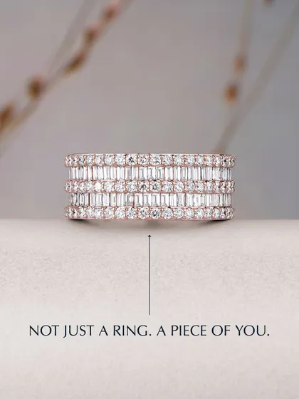 Not just a ring, but a piece of you. This wide eternity band is meticulously set with multiple rows of baguette and round diamonds, creating a statement of pure brilliance and sophisticated design. It is a testament to masterful craftsmanship.