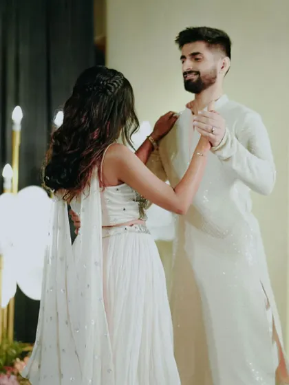 A tender moment from a couple's dance, showing the groom's gentle lead and the bride's trust.