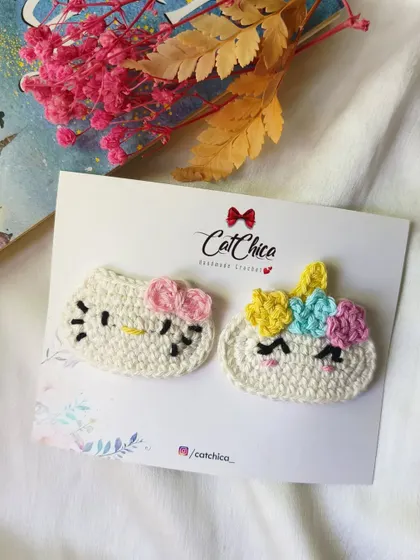 Fun character clips! This set features a Hello Kitty and a Unicorn design, both handmade with crochet.