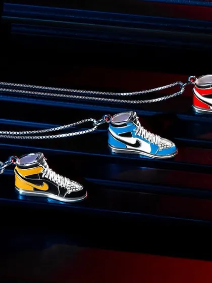 For these sneaker-themed pendants from Orionz Jewels, we used colored gels to create red and blue light streaks. This technique adds motion and energy to the shot, perfectly matching the product's streetwear vibe.