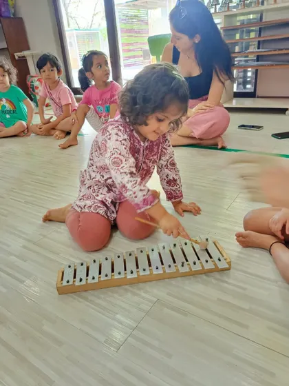 Another young musician explores the notes of the xylophone. Providing access to different instruments is key to our teaching philosophy.