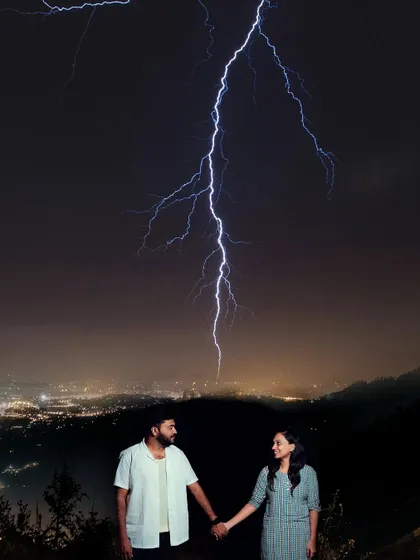 A breathtaking and dramatic pre-wedding shot capturing a couple under a bolt of lightning, showcasing our ability to create truly unique images.