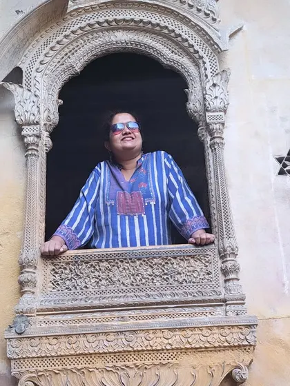 Peeking out of a 'jharokha' window in a Jaisalmer haveli. These architectural details are as beautiful as they are functional.