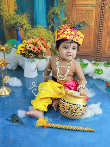 This little Krishna looks so serene and happy. The floral elements and peacock in the background add layers of beauty to the composition.