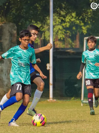 A player dribbles forward, showcasing agility and ball control.