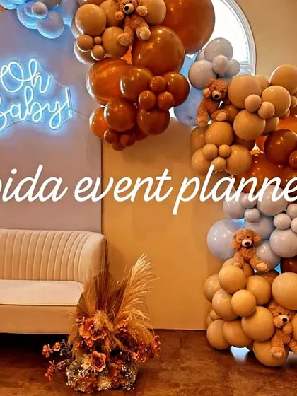 A close-up of our 'Oh Baby' neon sign against a backdrop, with teddy bears nestled into the balloon arrangements for a cute touch.