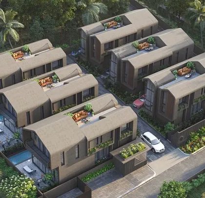 An aerial view of the Vagator Villas masterplan. The design arranges six individual homes with private pools and roof gardens, creating a low-rise, high-density community with a focus on outdoor living.