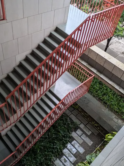 A high-angle view of a staircase at the JSW Administrative Office in Vasind. This image was taken during a walkthrough where our designers experienced the project's material choices and spatial zoning firsthand.