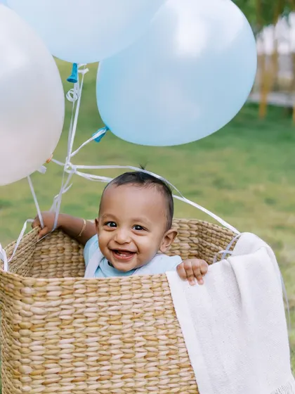 Another joyful baby in the hot air balloon basket. This prop is a definite favorite for first birthday photoshoots.