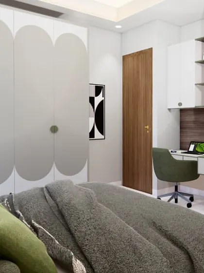 This bedroom design for our Sigma-1 project in Greater Noida is a study in simplicity. The room features a calming green color palette, a fluted wall panel behind the TV, and a compact study desk.