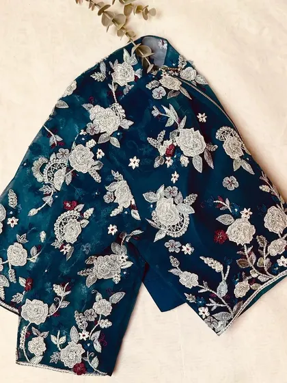 A beautiful teal velvet blouse with all-over floral embroidery in silver, a perfect blend of traditional and modern aesthetics.