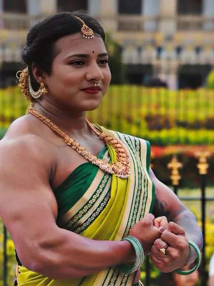 A gorgeous build. This photo from my shoot near the Vidhana Soudha shows my physique in a classic bodybuilding pose, framed by a beautiful green and gold saree.