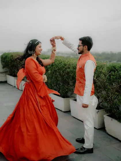 A beautiful shot of Sugandha and Ashish sharing a dance on a rooftop with mountains in the background. This photo combines romance, elegance, and the beauty of a destination wedding.
