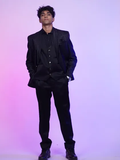 A full-length shot of the black tuxedo, showing its sharp, modern fit. Perfect for any formal occasion.