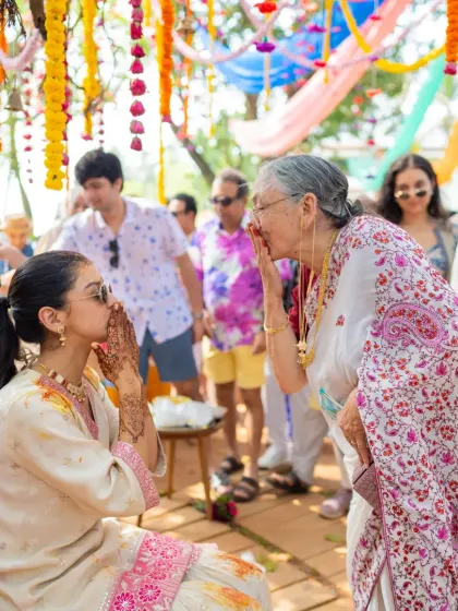 A wider shot of the blessings ceremony, showing the colorful and festive backdrop. I ensure the decor enhances the beauty of every ritual.