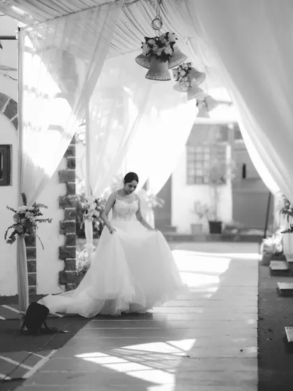 A beautiful shot of the bride walking down a path, her dress flowing, capturing a moment of quiet grace before the ceremony.