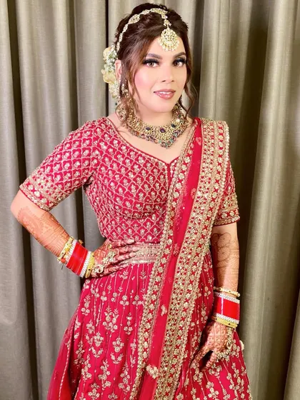 A three-quarter shot showing her confident pose and the beautiful detailing on her blouse and jewelry.