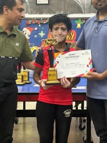 A player receives his trophy and merit certificate, marking another successful tournament outing for the Joshi TT Academy.