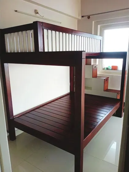 A side angle of the bunk bed, showing its sturdy construction and how it fits neatly into the corner of the room, maximizing floor space for play.