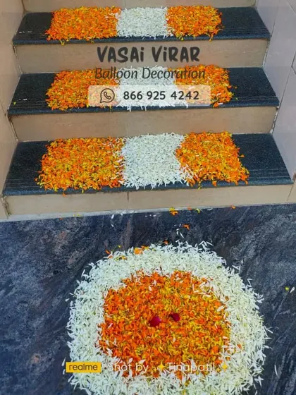 The celebration starts right at the doorstep. For this welcome home decoration, I created a lovely flower rangoli at the entrance and decorated the stairs with patterns of white and orange flower petals.