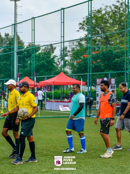 Referees lead the teams onto the pitch, signifying the professional standards we uphold. We ensure every match is officiated fairly and consistently.