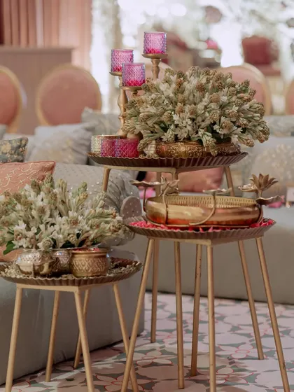 A close-up of the side table decor, showing how we layer different elements like floral arrangements, candles, and brass trays to create visually interesting compositions.