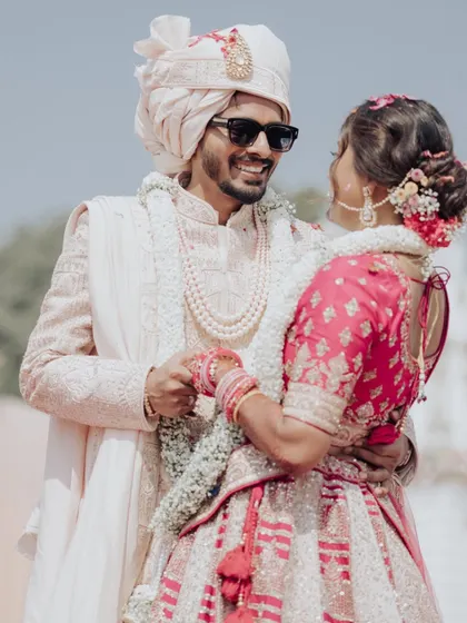 A joyful, candid moment between Shreya and Harsh during their wedding ceremony, their smiles lighting up the frame.