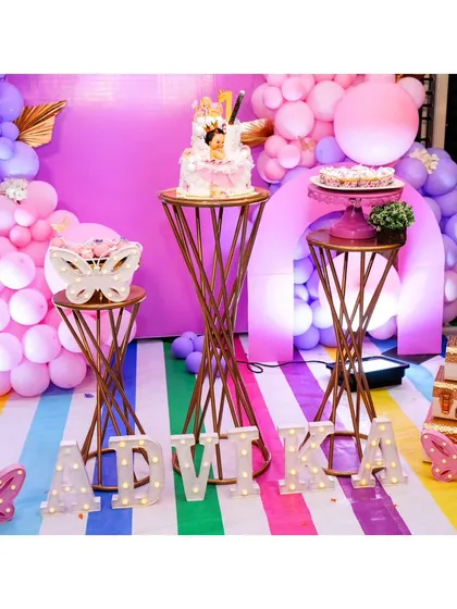 A close-up of the cake and dessert tables with the marquee letter's spelling 'ADVIKA'.